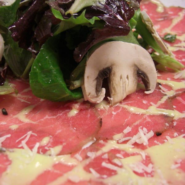 Monticello at Red Bank's beef carpaccio with mushrooms, greens, cheese, and a creamy sauce.