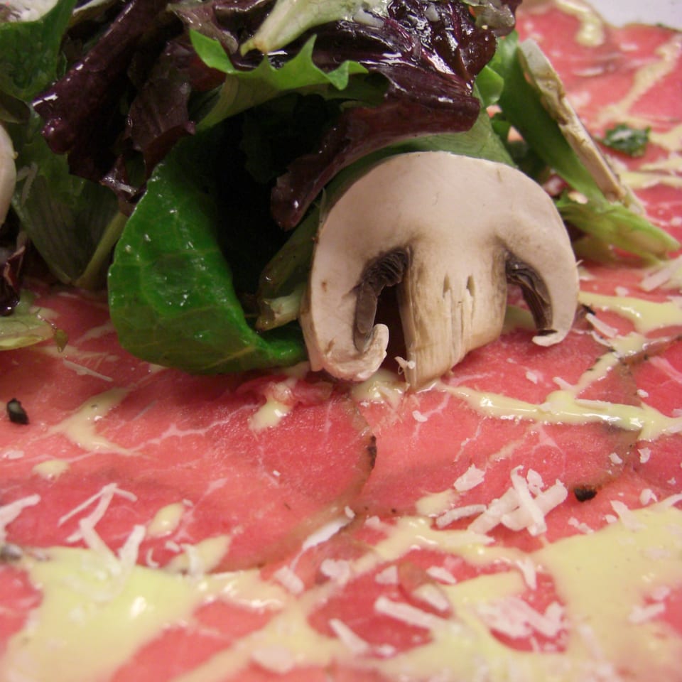Monticello at Red Bank's beef carpaccio with mushrooms, greens, cheese, and a creamy sauce.
